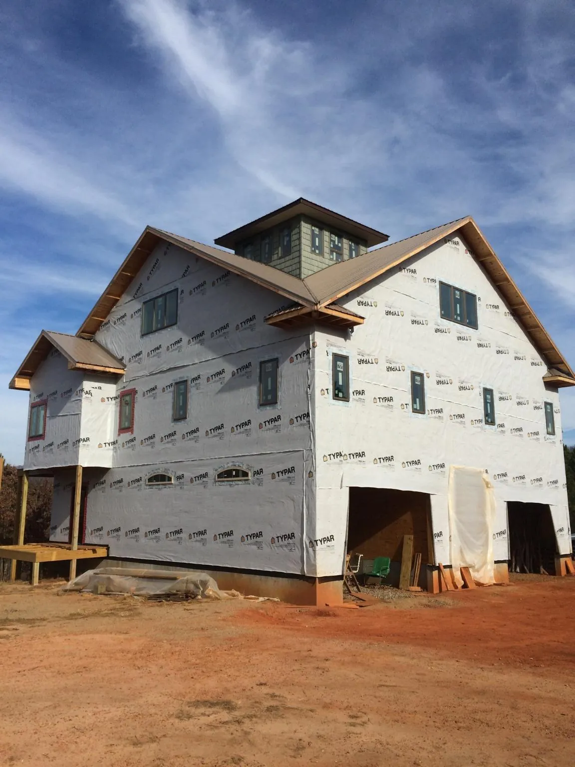 New two story house under construction with a cupola and gabled roofs in Falkland